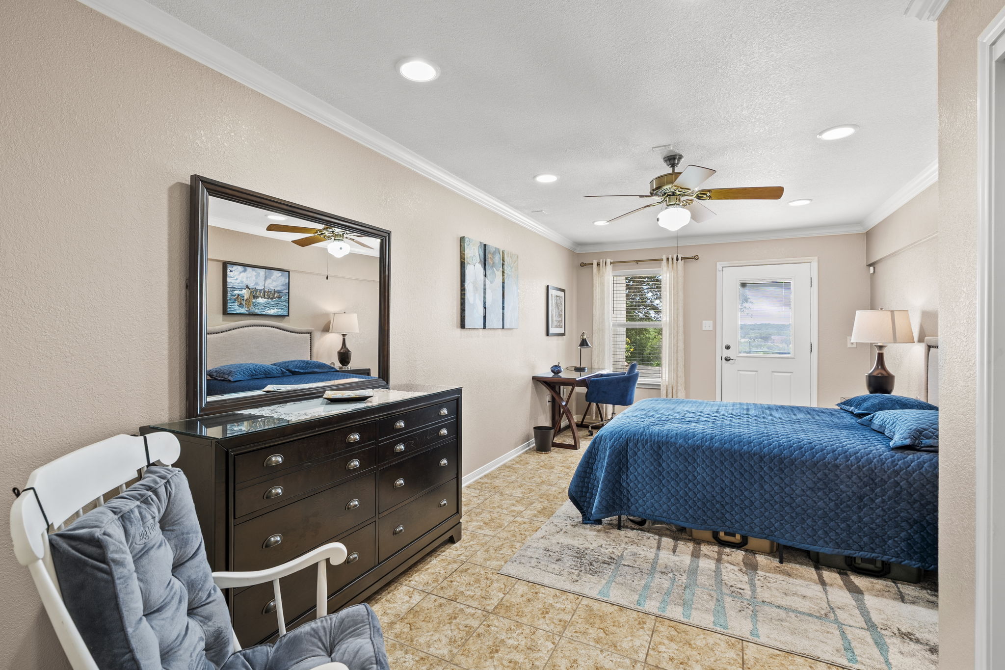 1427 River Ridge Ranch Road Killeen, TX 76549 - Photo 23 of 40 Natural light illuminates this oversized downstairs bedroom, complete with elegant crown molding, an exterior door, and recessed lighting.