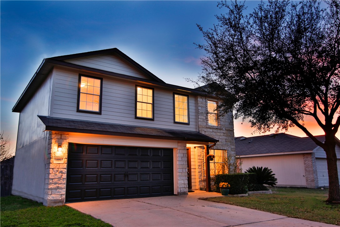 115 Phillips Street Hutto, TX 78634 - Photo 1 of 1 a front view of a house with a yard and garage