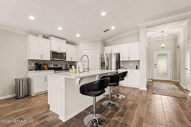 a kitchen with a sink appliances and cabinets