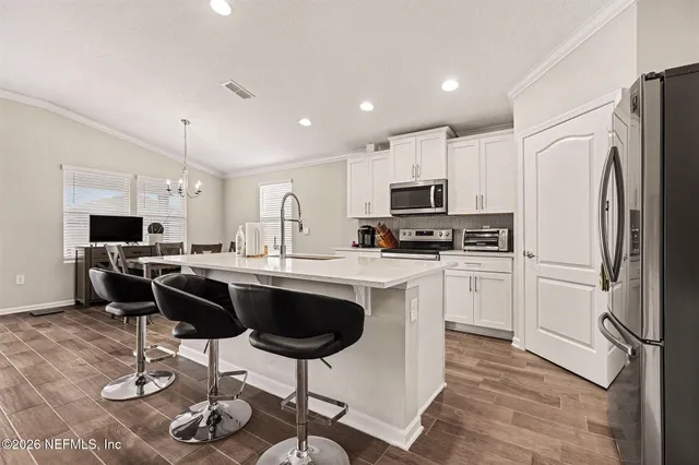 a white toilet sitting next to a bathroom sink and a mirror