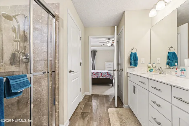 a en suite bathroom with a tub shower and a sink