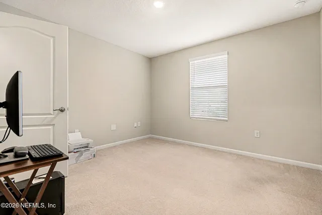 a view of a livingroom with a flat screen tv and wooden floor
