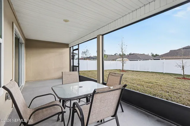 a view of a chairs and table in the balcony