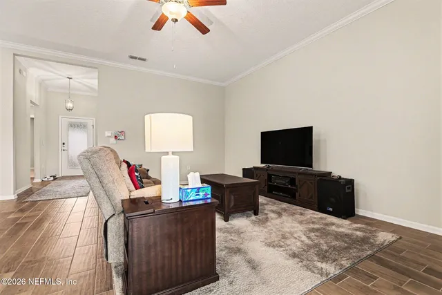 a living room with furniture and a view of kitchen