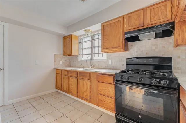 a kitchen with granite countertop cabinets stainless steel appliances and a sink