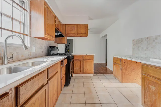 a kitchen with a sink and a refrigerator