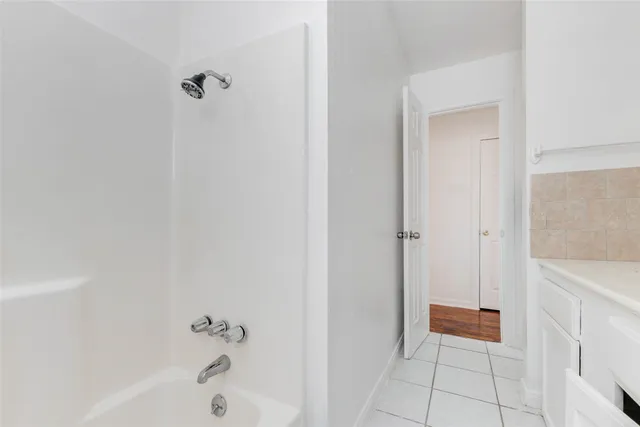a bathroom with a bathtub and shower