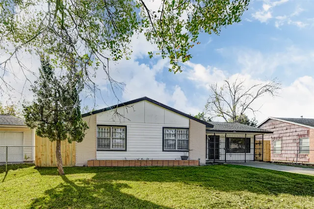 a house that has a tree in front of the house