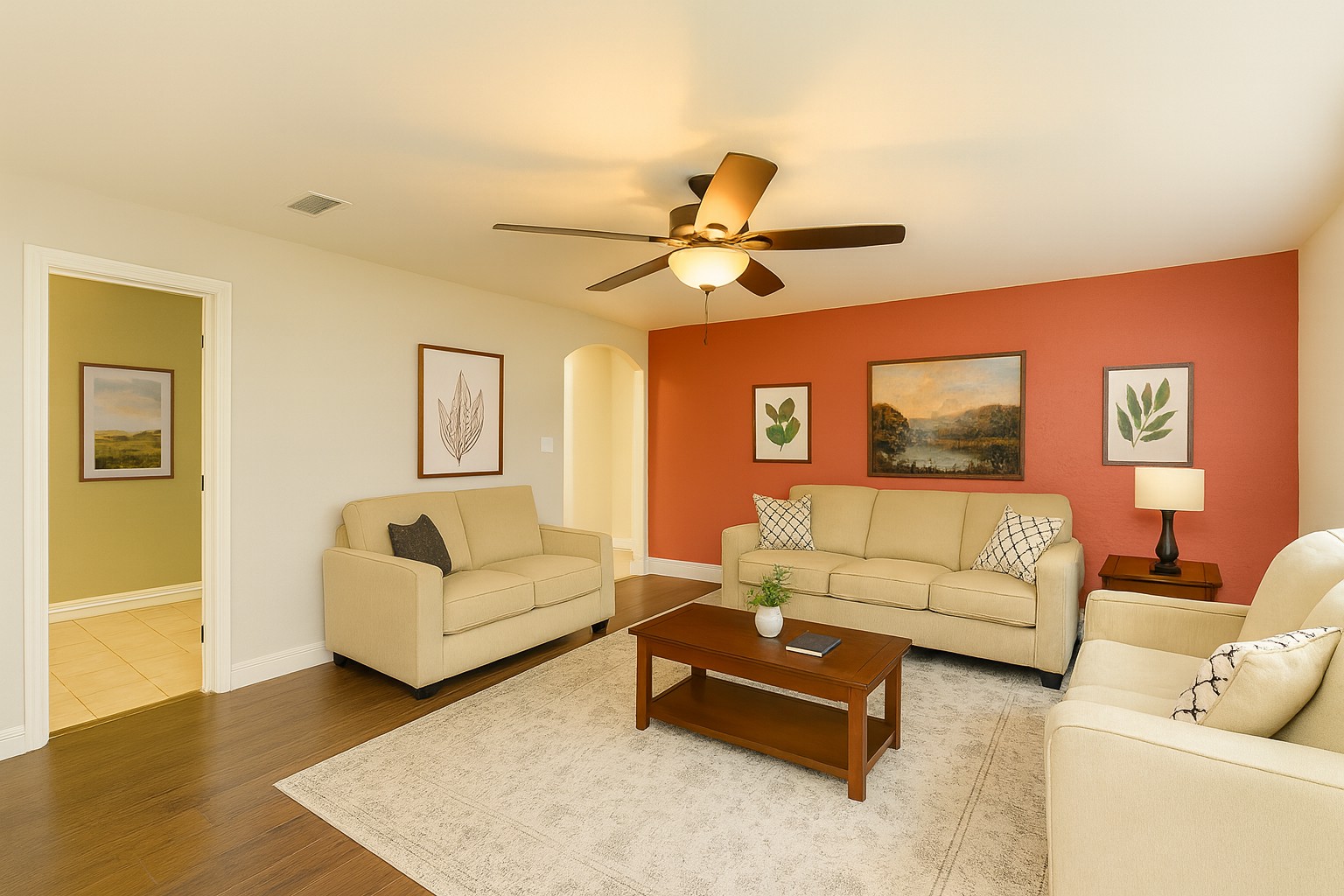 Virtually staged - Living area featuring arched walkways, wood finished floors, and ceiling fan