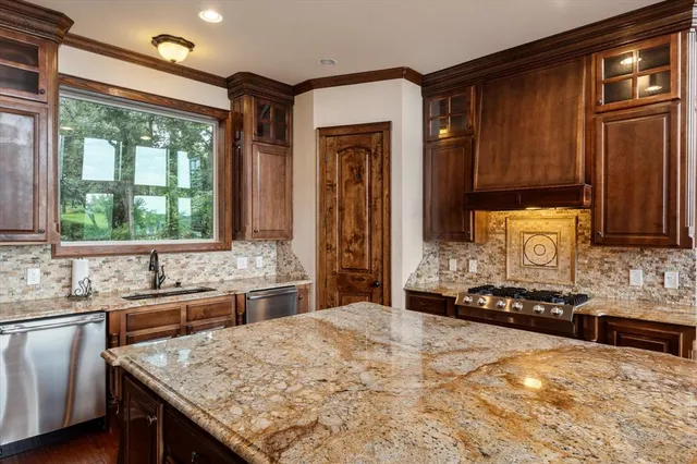 a kitchen with a stove a sink and a refrigerator