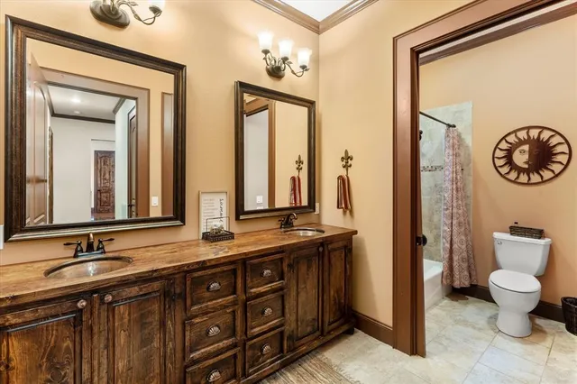 a bathroom with a granite countertop sink and a large mirror