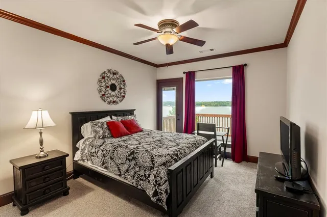 a bedroom with a bed desk and a window
