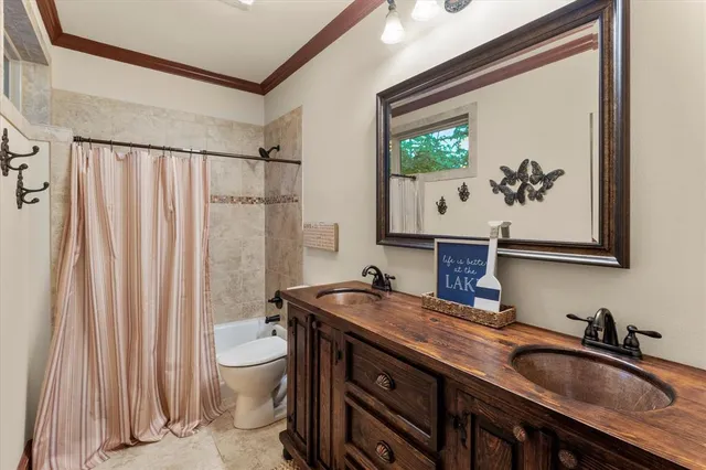 a bathroom with a granite countertop sink a toilet and a mirror