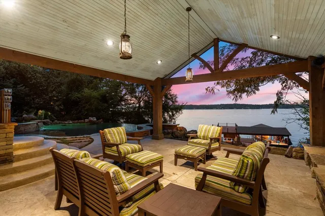 a patio with patio couch and a fire pit