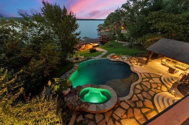 an aerial view of a house with yard swimming pool and outdoor seating