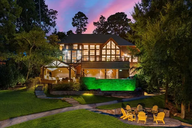 a view of a house with a yard fire pit and outdoor seating