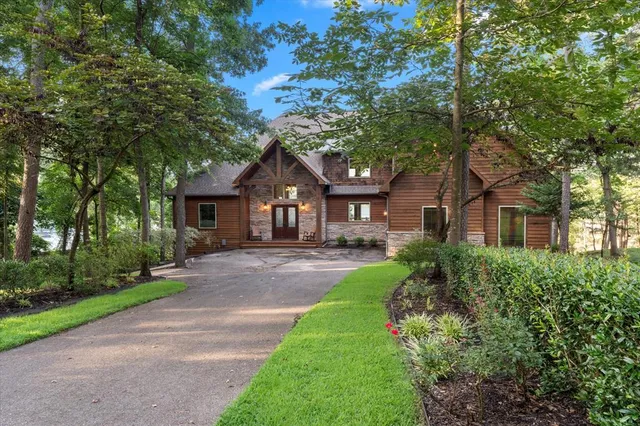 a front view of a house with yard and green space