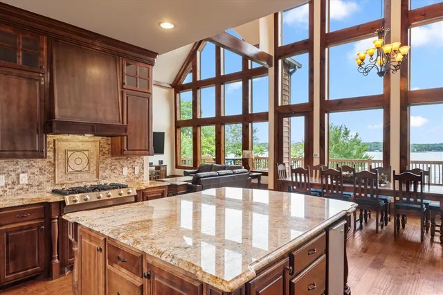 a kitchen with a stove a sink and cabinets