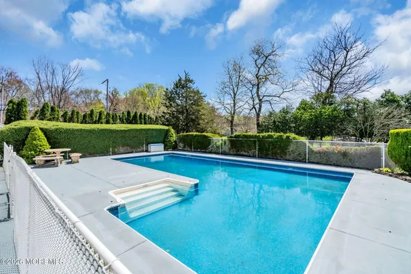 a view of a swimming pool and a yard