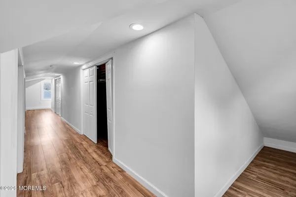 a view of an empty room and wooden floor