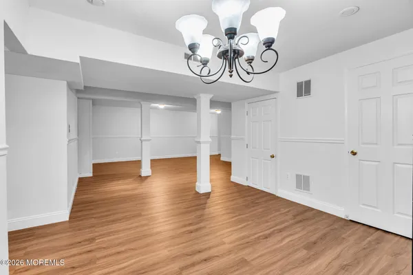 a view of a room with wooden floor