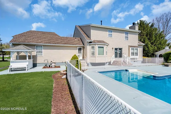 a view of a house with backyard and sitting area