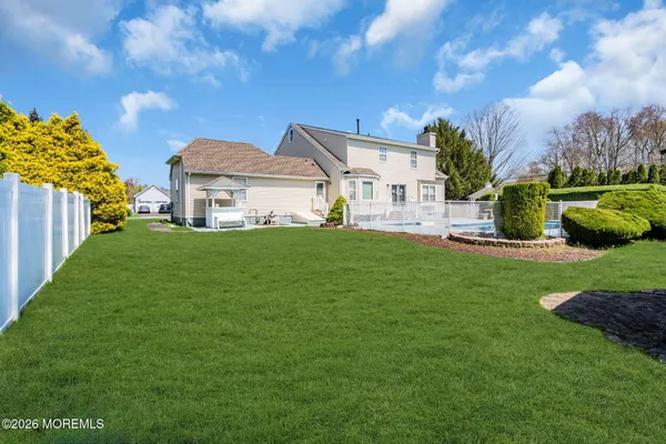 a view of a house with a big yard and potted plants