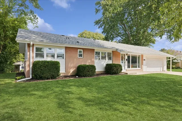 a view of a house with a yard and plants