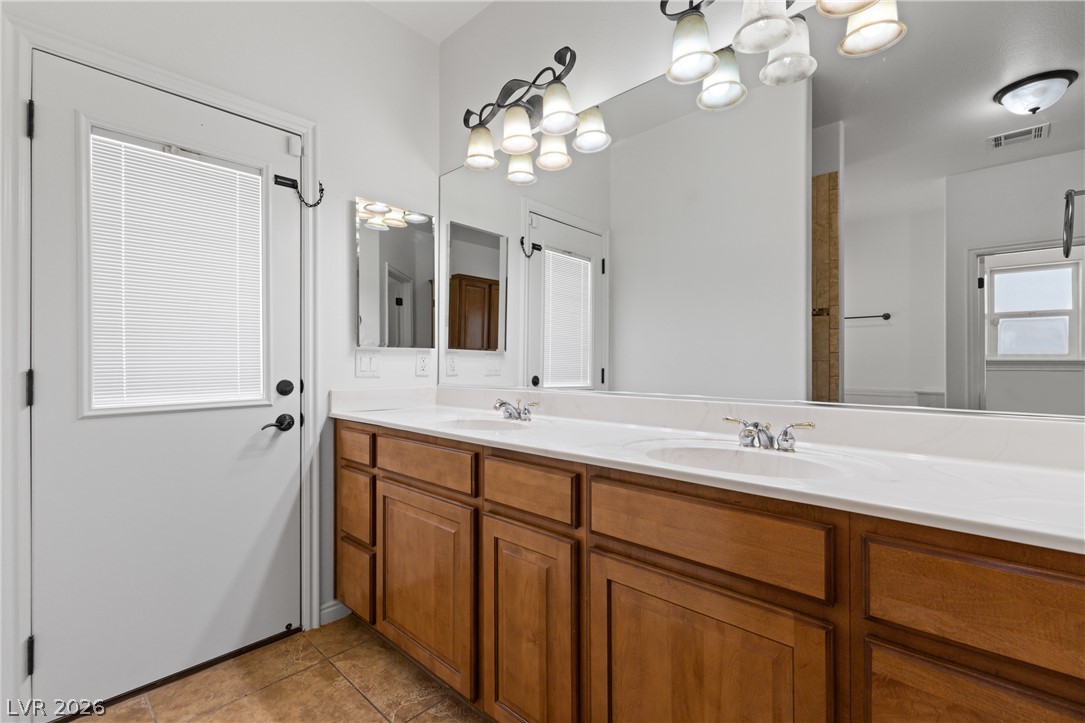 575 Gann Avenue Logandale, NV 89021 - Photo 35 of 75 A well-appointed bathroom offers a dual vanity with abundant counter and storage space.