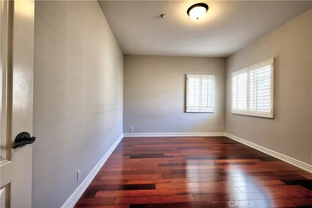 a bathroom with a granite countertop sink a toilet a mirror and shower