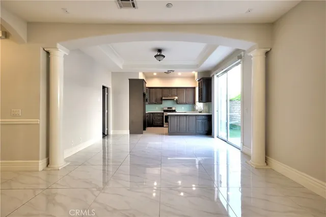 a view of a kitchen with a sink and a refrigerator