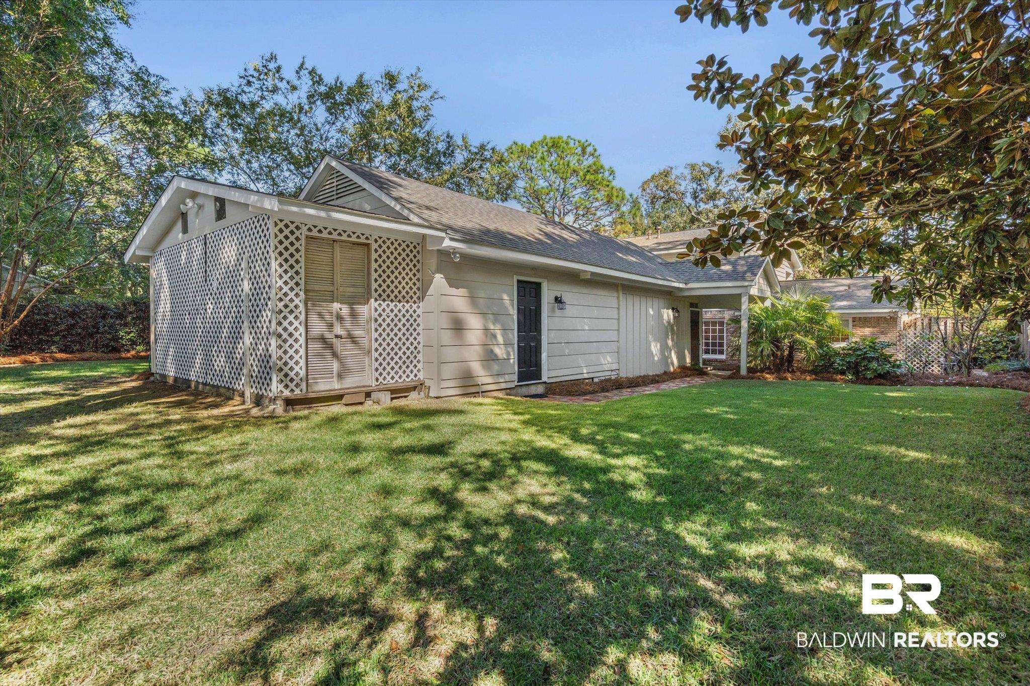 513 Spring Park Drive East Mobile, AL 36608 - Photo 36 of 44 Back of property featuring a lawn and roof with shingles