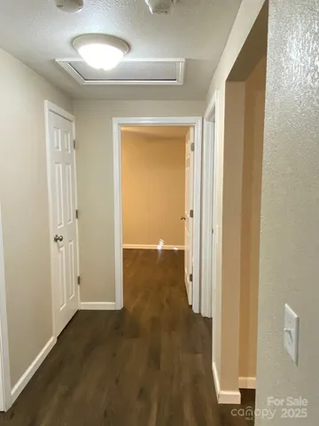a view of a hallway with wooden floor