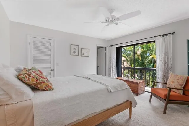 a bedroom with bed and a large window