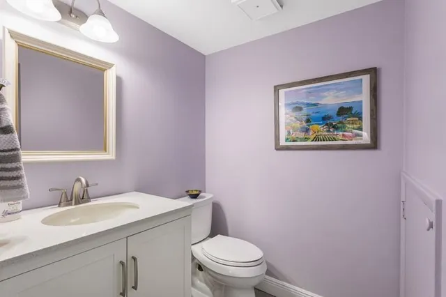a bathroom with a toilet a sink and mirror