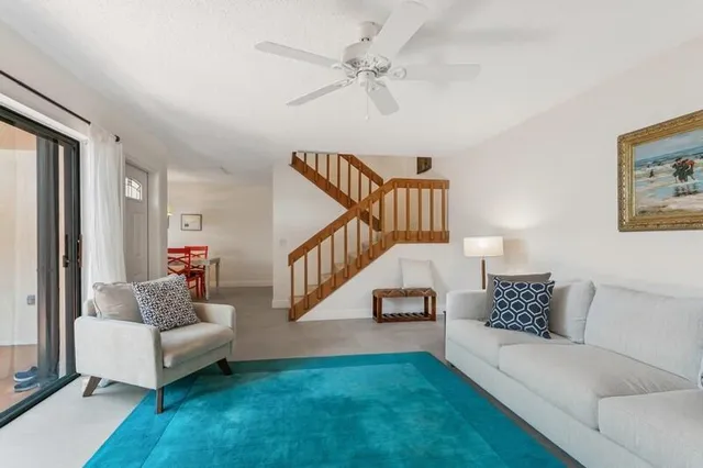a living room with furniture and a stairs