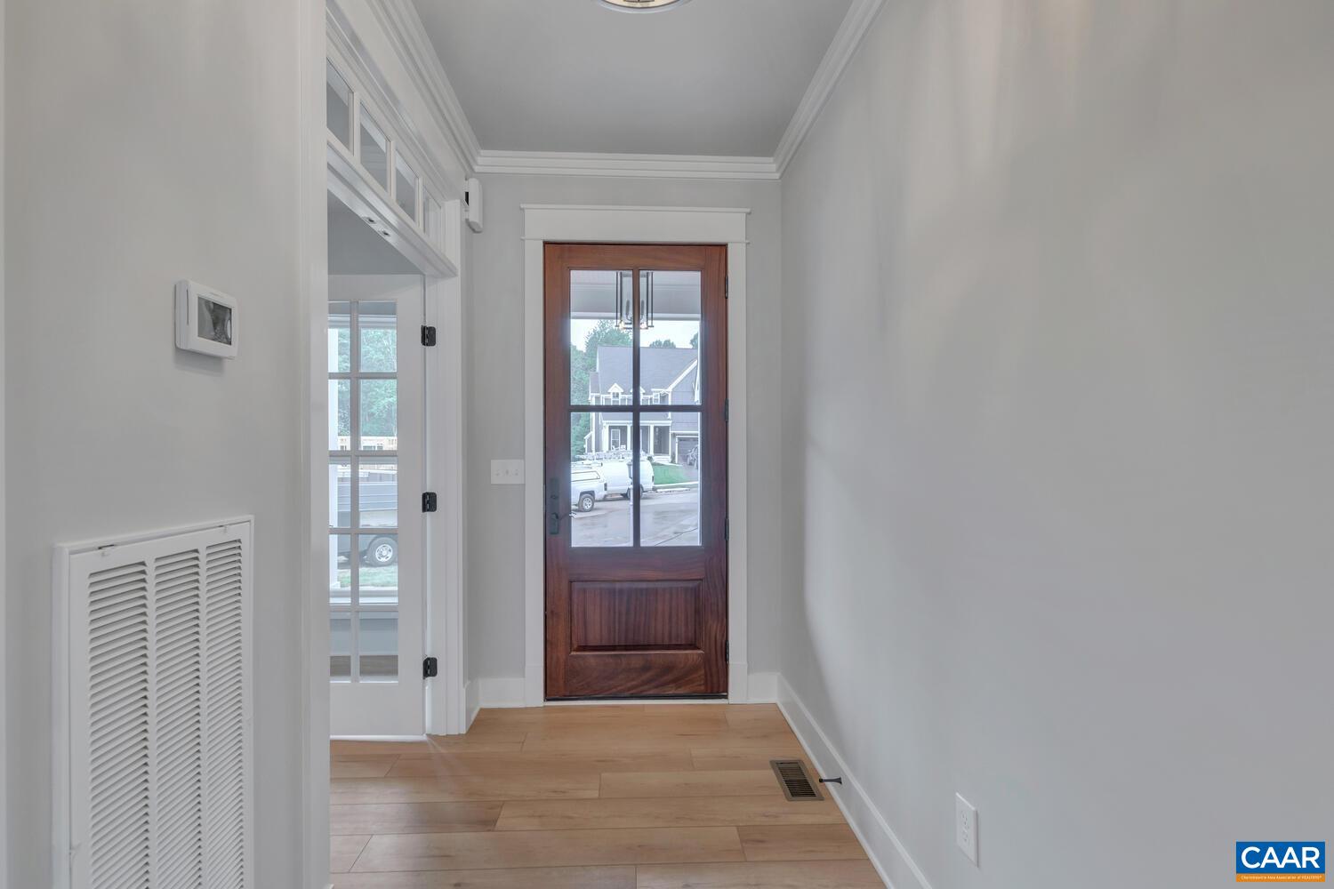 169 Agatha Ridge Lane Crozet, VA 22932 - Photo 16 of 73 a view of a hallway to a livingroom with wooden floor and a window