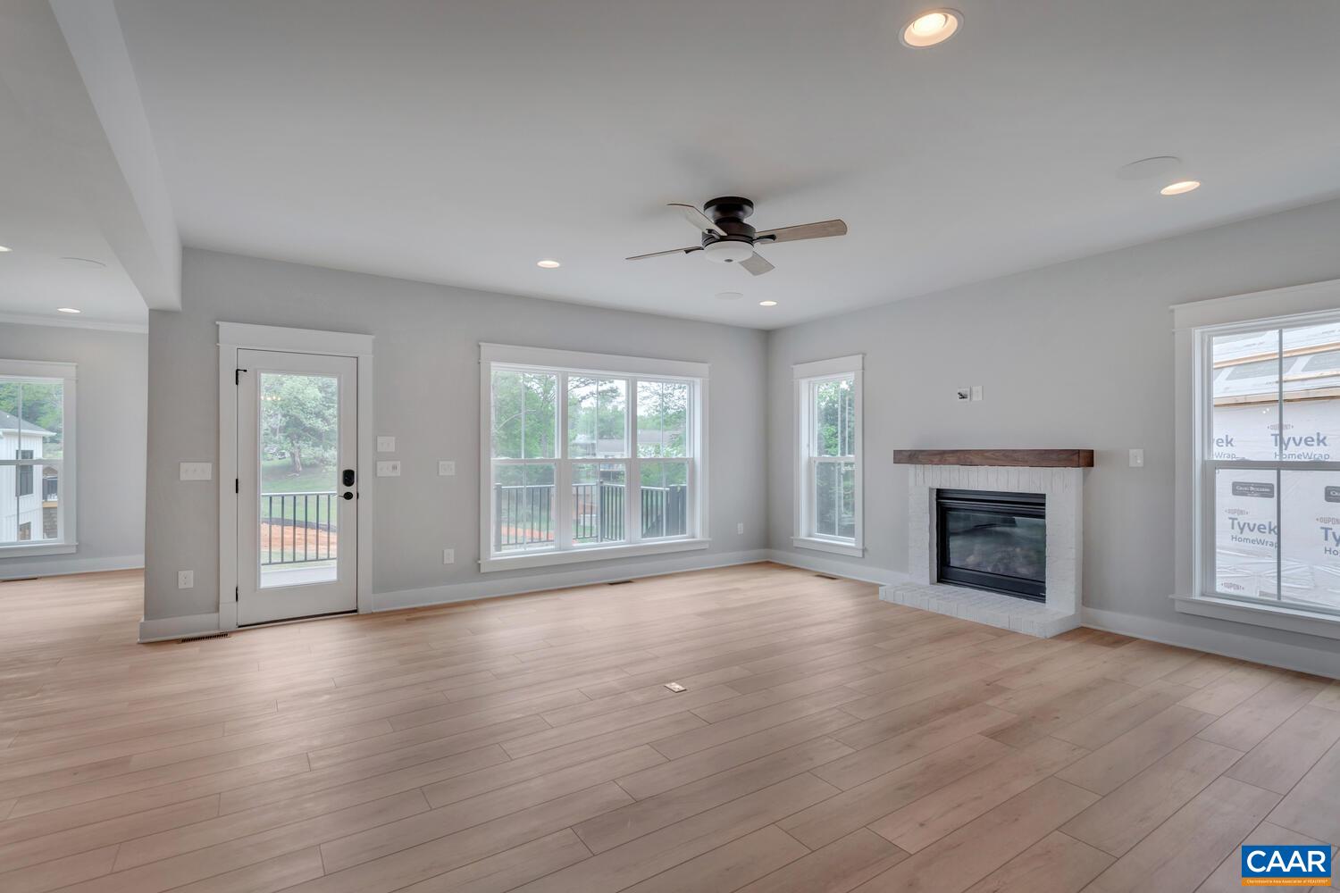 169 Agatha Ridge Lane Crozet, VA 22932 - Photo 22 of 73 a view of an empty room with wooden floor fireplace and a window