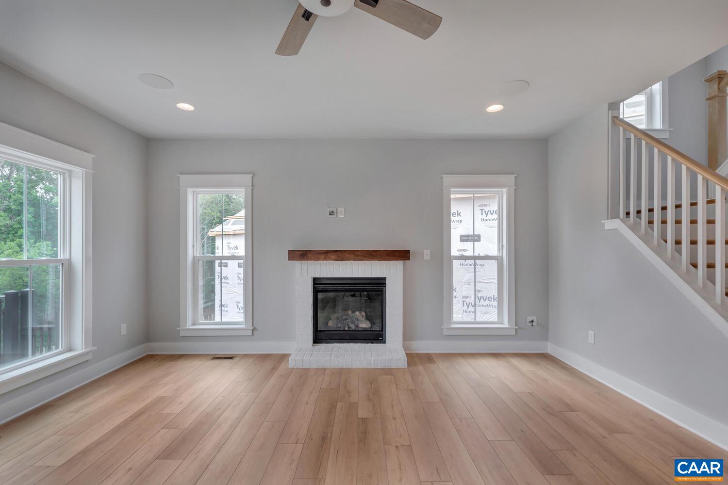 169 Agatha Ridge Lane Crozet, VA 22932 - Photo 24 of 73 an empty room with wooden floor fireplace and windows