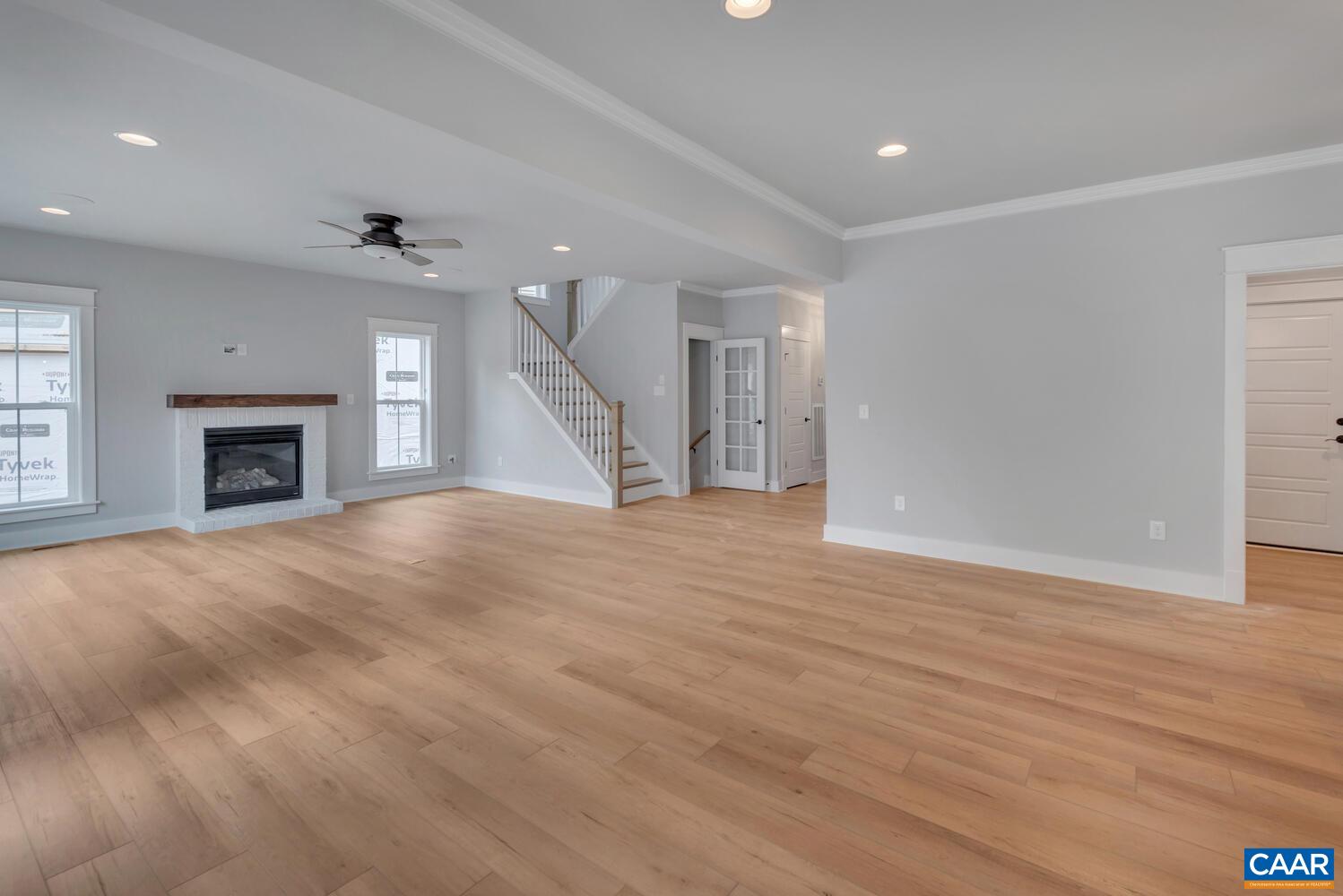 169 Agatha Ridge Lane Crozet, VA 22932 - Photo 30 of 73 an empty room with wooden floor a fireplace and windows