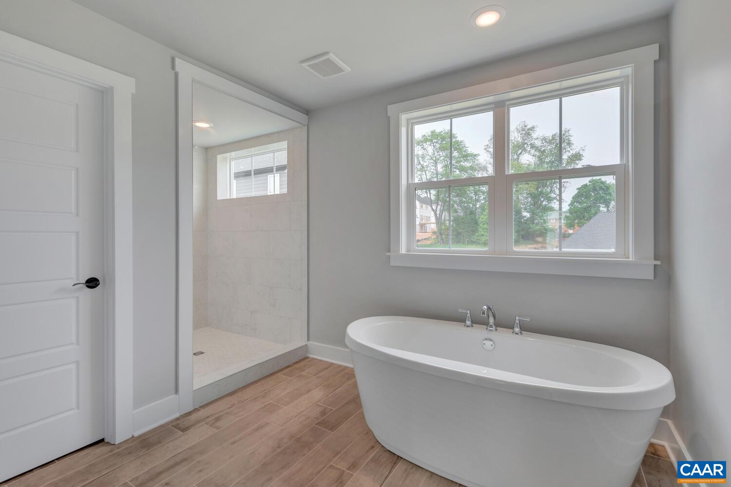 169 Agatha Ridge Lane Crozet, VA 22932 - Photo 44 of 73 a white bath tub sitting in a bathroom next to a window