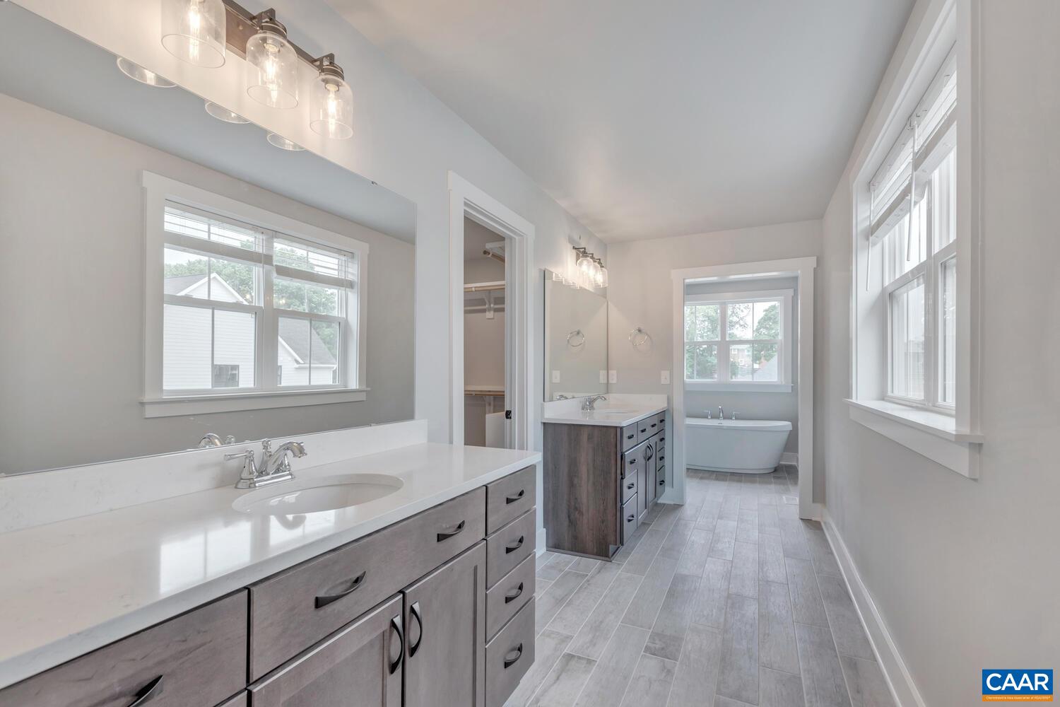 169 Agatha Ridge Lane Crozet, VA 22932 - Photo 47 of 73 a bathroom with a granite countertop sink a mirror and a bathtub