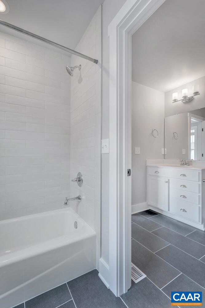 169 Agatha Ridge Lane Crozet, VA 22932 - Photo 57 of 73 a bathroom with a bathtub a shower a sink and a window