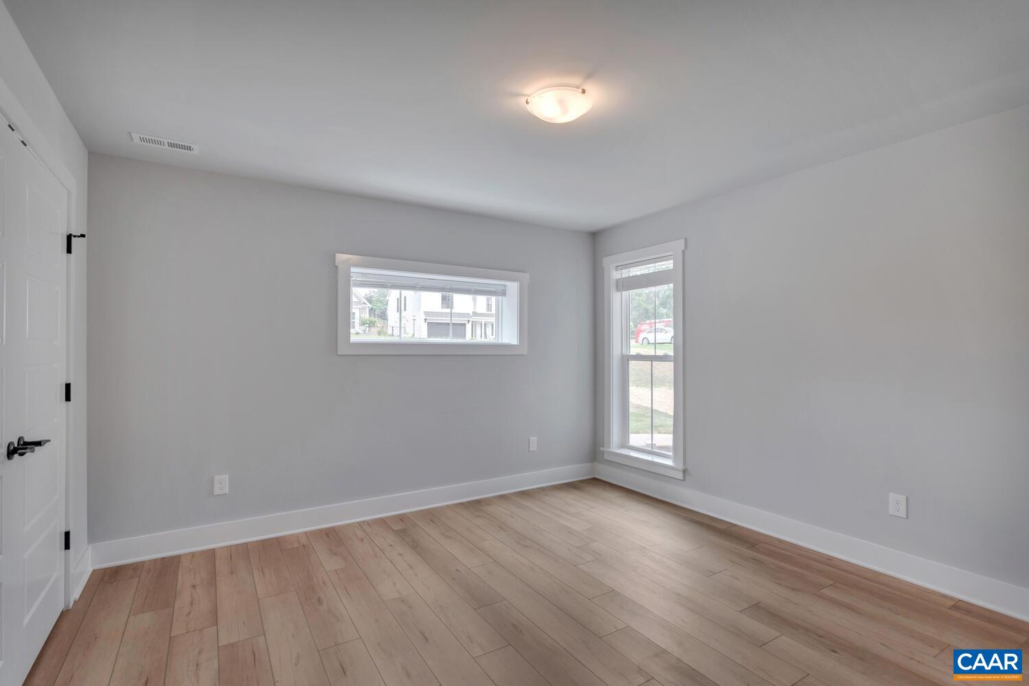 169 Agatha Ridge Lane Crozet, VA 22932 - Photo 71 of 73 an empty room with wooden floor and windows