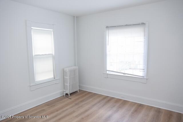 220 Clark Avenue Clarks Summit, PA 18411 - Photo 17 of 25 an empty room with wooden floor and windows