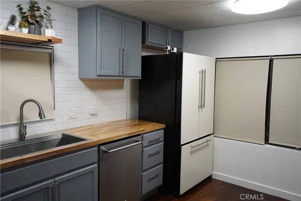 a kitchen with a refrigerator and a sink