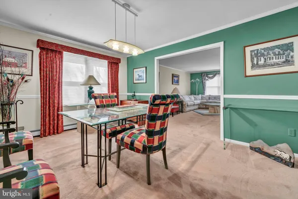 a bedroom with furniture and a large window