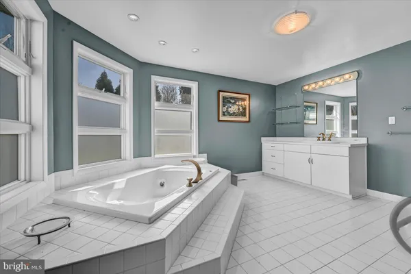 a white bath tub sitting next to a window