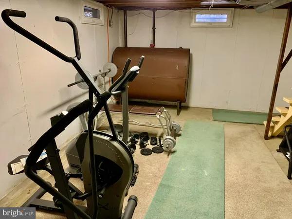 a room with gym equipment and mirror