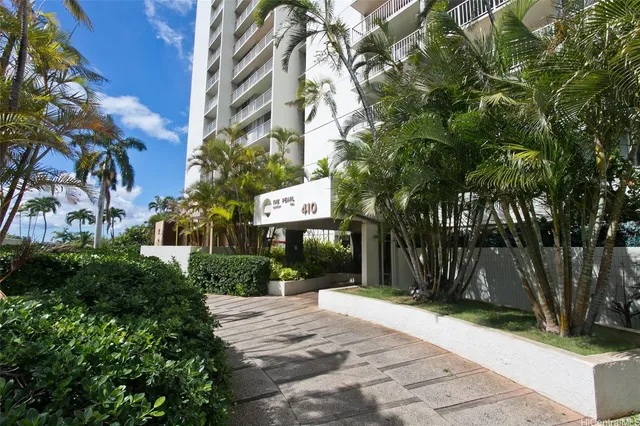 a front view of a house with a yard and tree s